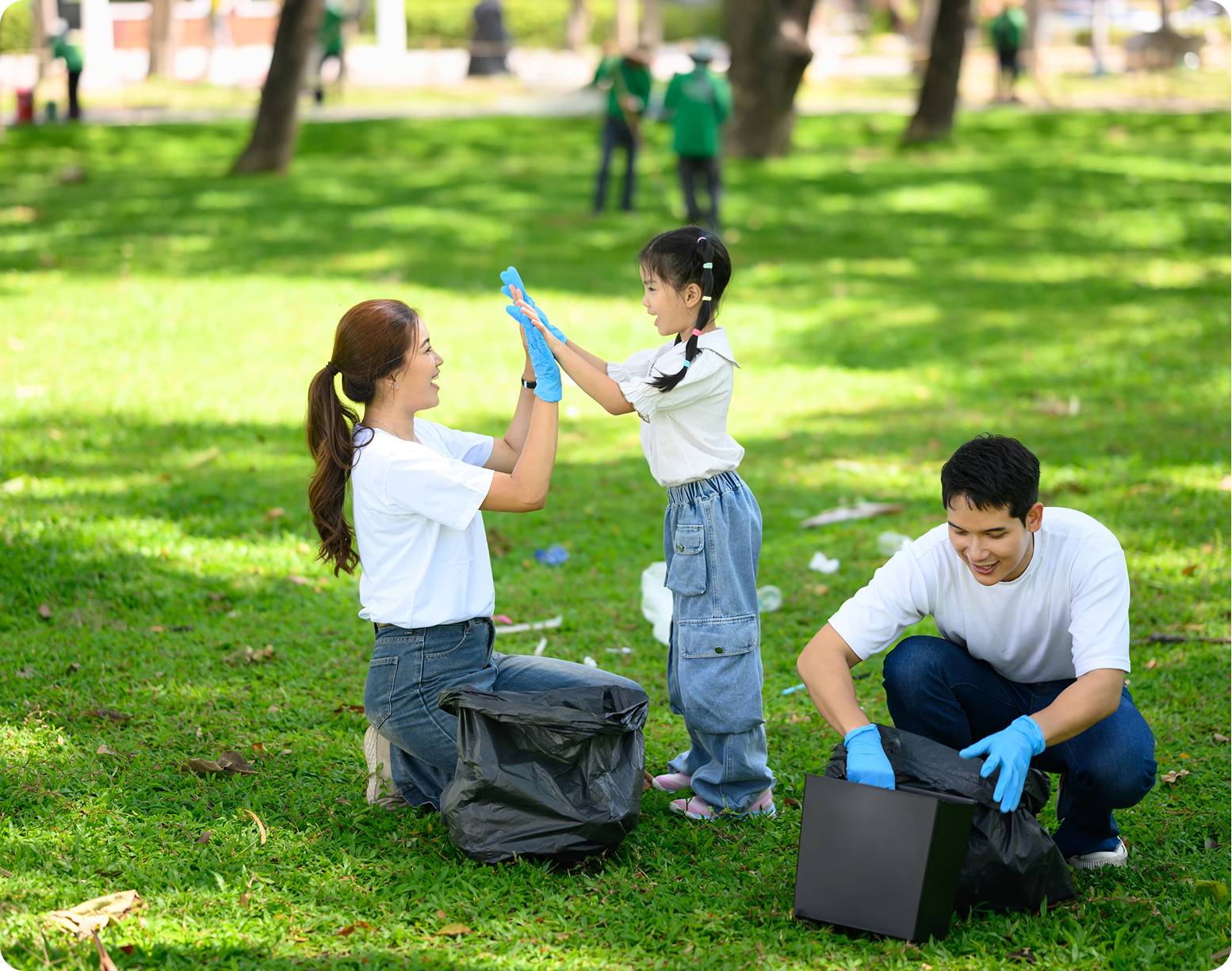 Family collecting litter in a park